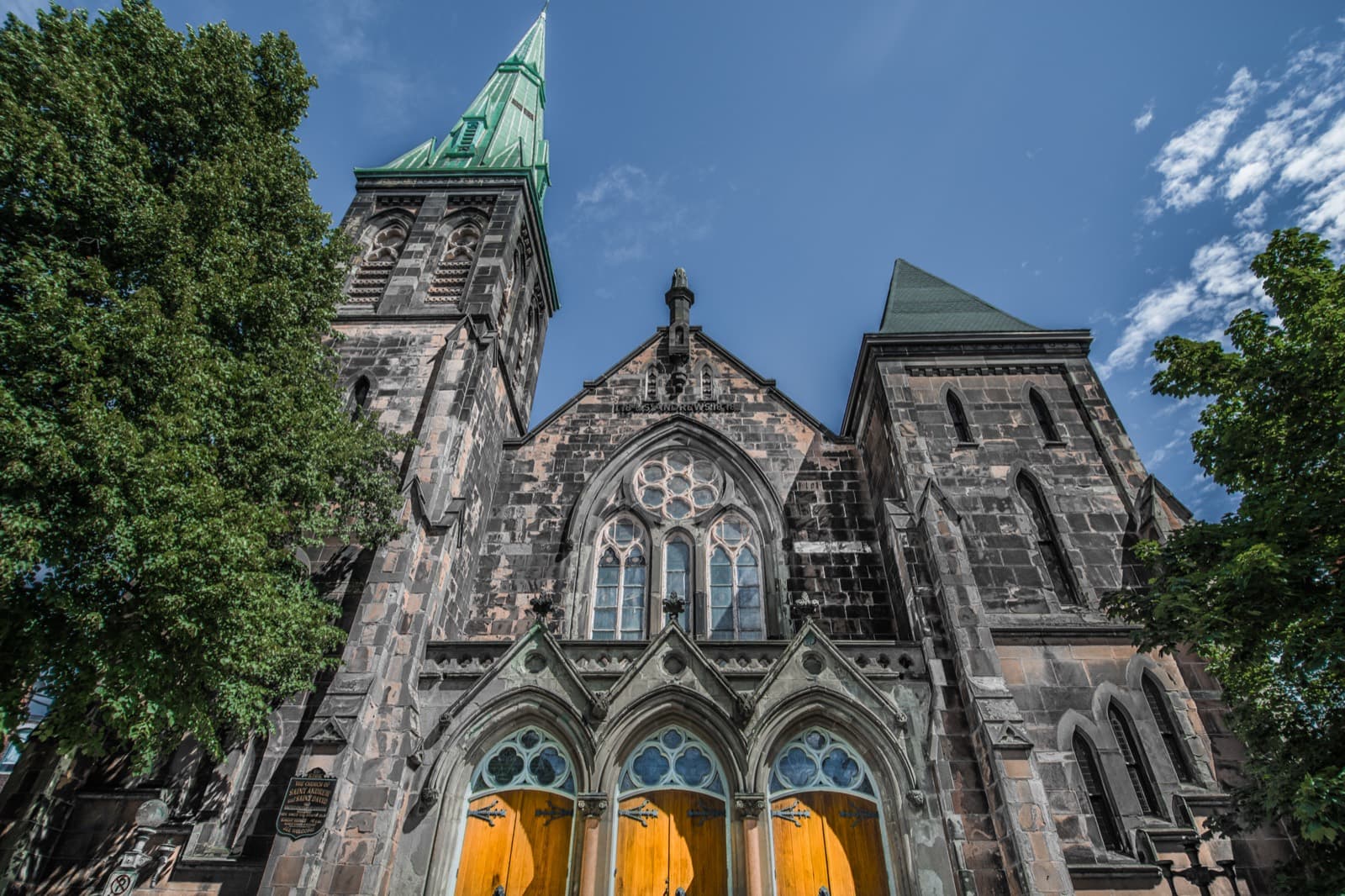 Stone church with green copper spires in uptown Saint John